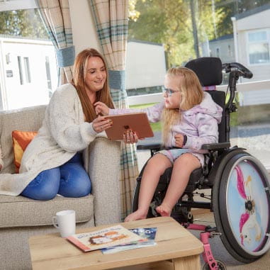 Little girl in wheelchair with mum