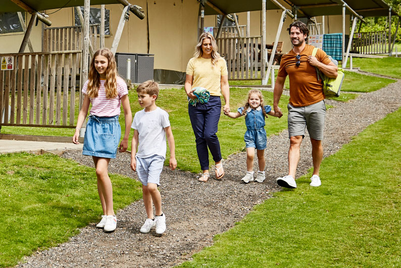 Family walking hand in hand through Parkdean Resorts