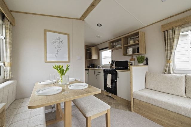 a bright and airy kitchen and dining area in a caravan