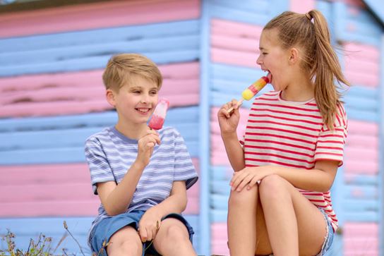 Little boy and girl eating ice creams