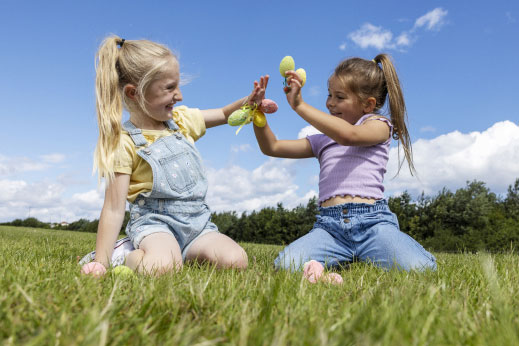 Little girls playing with plastic easter eggs